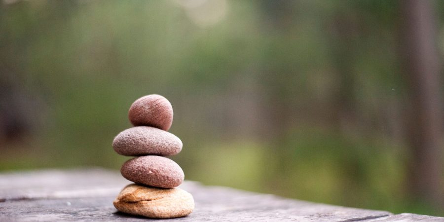 Balance and tranquility embodied by stacked stones in a natural outdoor setting.